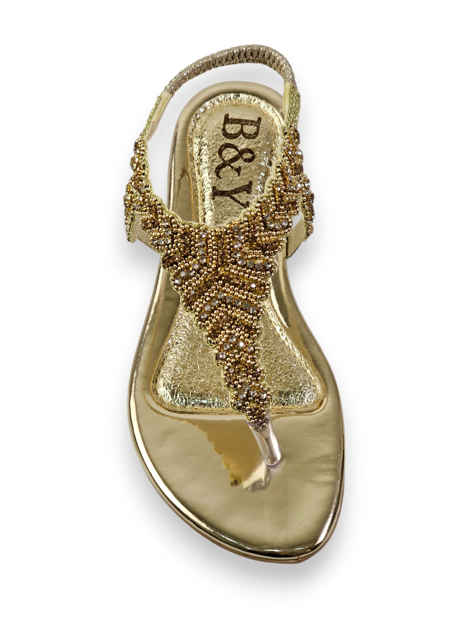 A gold-colored, embellished sandal with a metallic, beaded design.