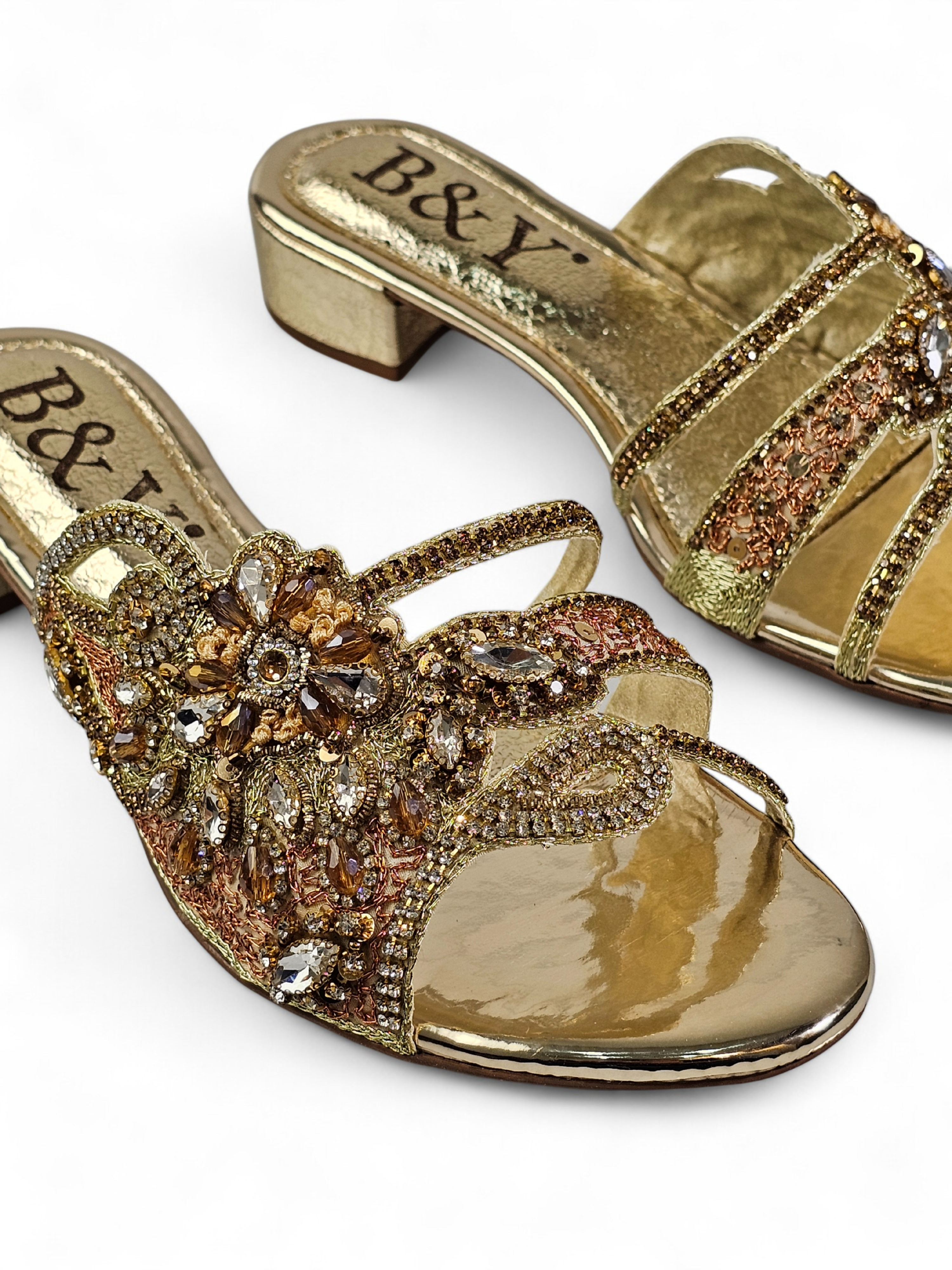 Sandália artesanal dourada com pedrarias florais em tons de dourado, champagne, bronze e prata, feita à mão com salto baixo espelhado.