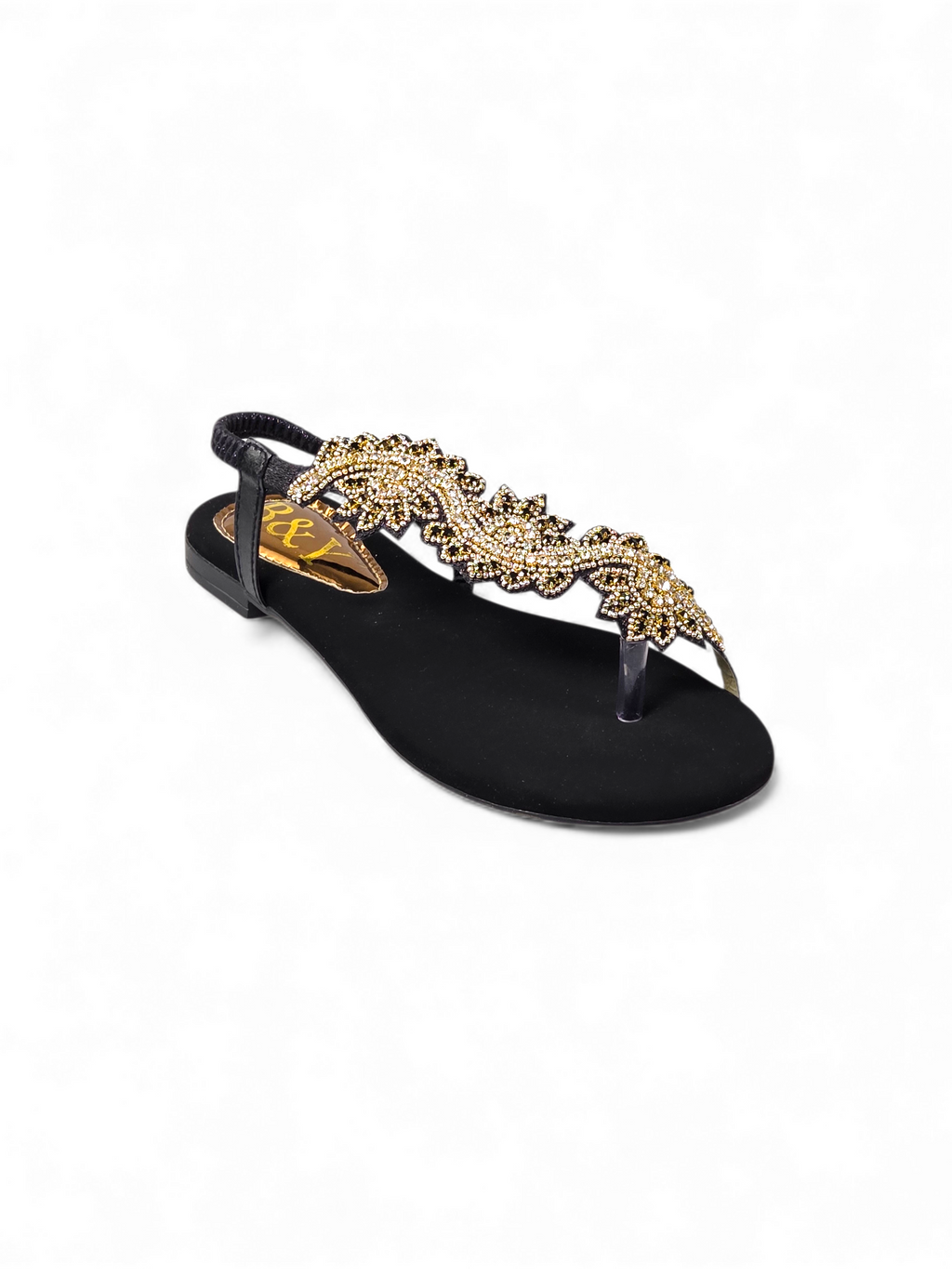 A black sandal with a decorative gold leaf design on the toe area.