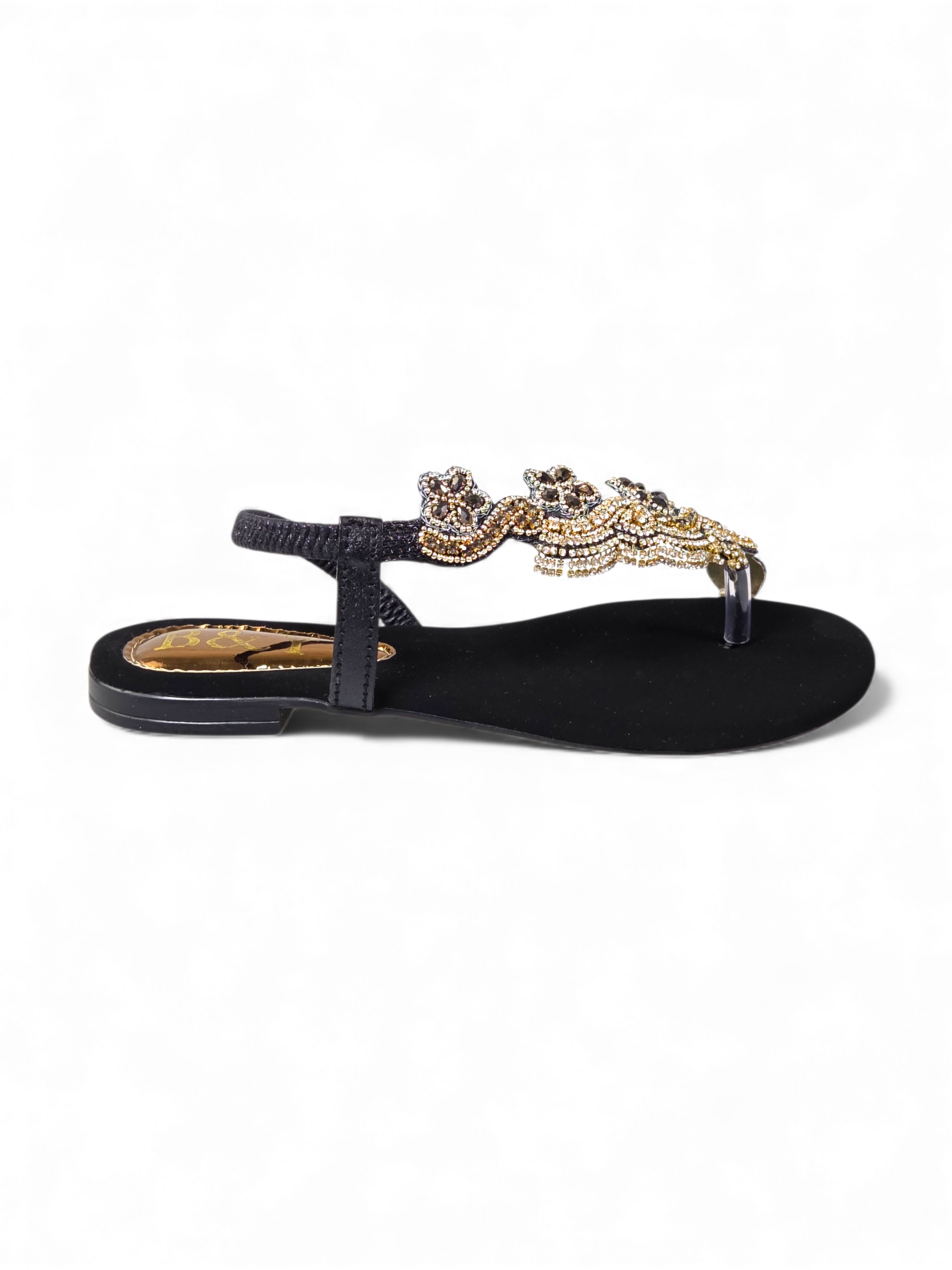 A black sandal with a decorative beaded embellishment on the toe area.