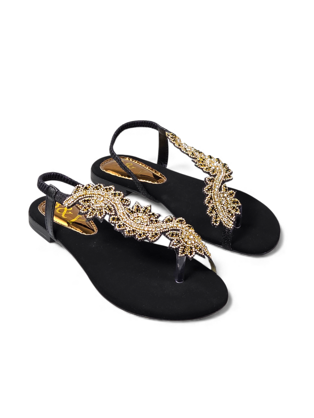 A pair of black sandals with gold embellishments on the toe straps.