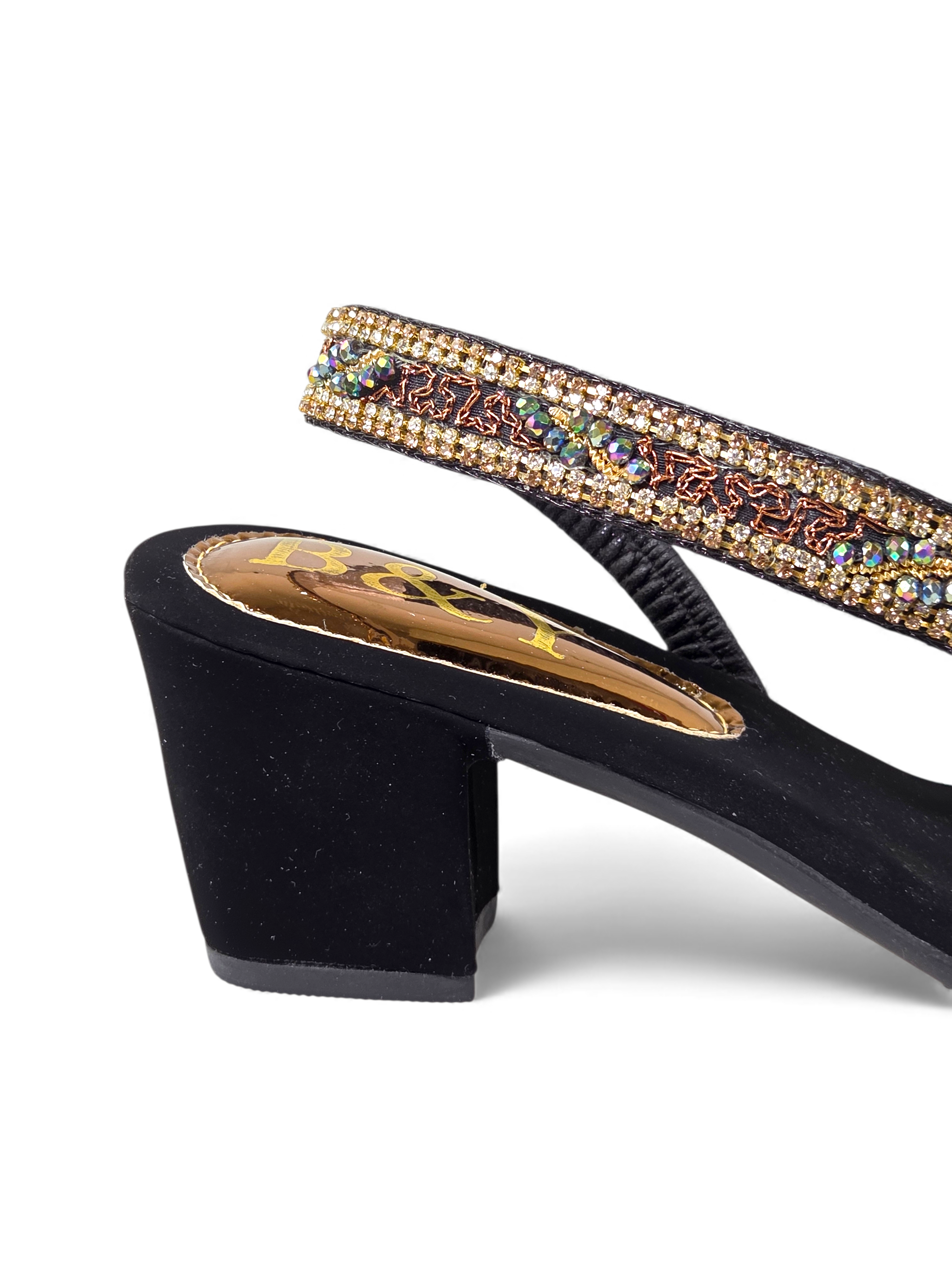 A close-up view of a black high-heeled shoe with a decorative beaded strap.
