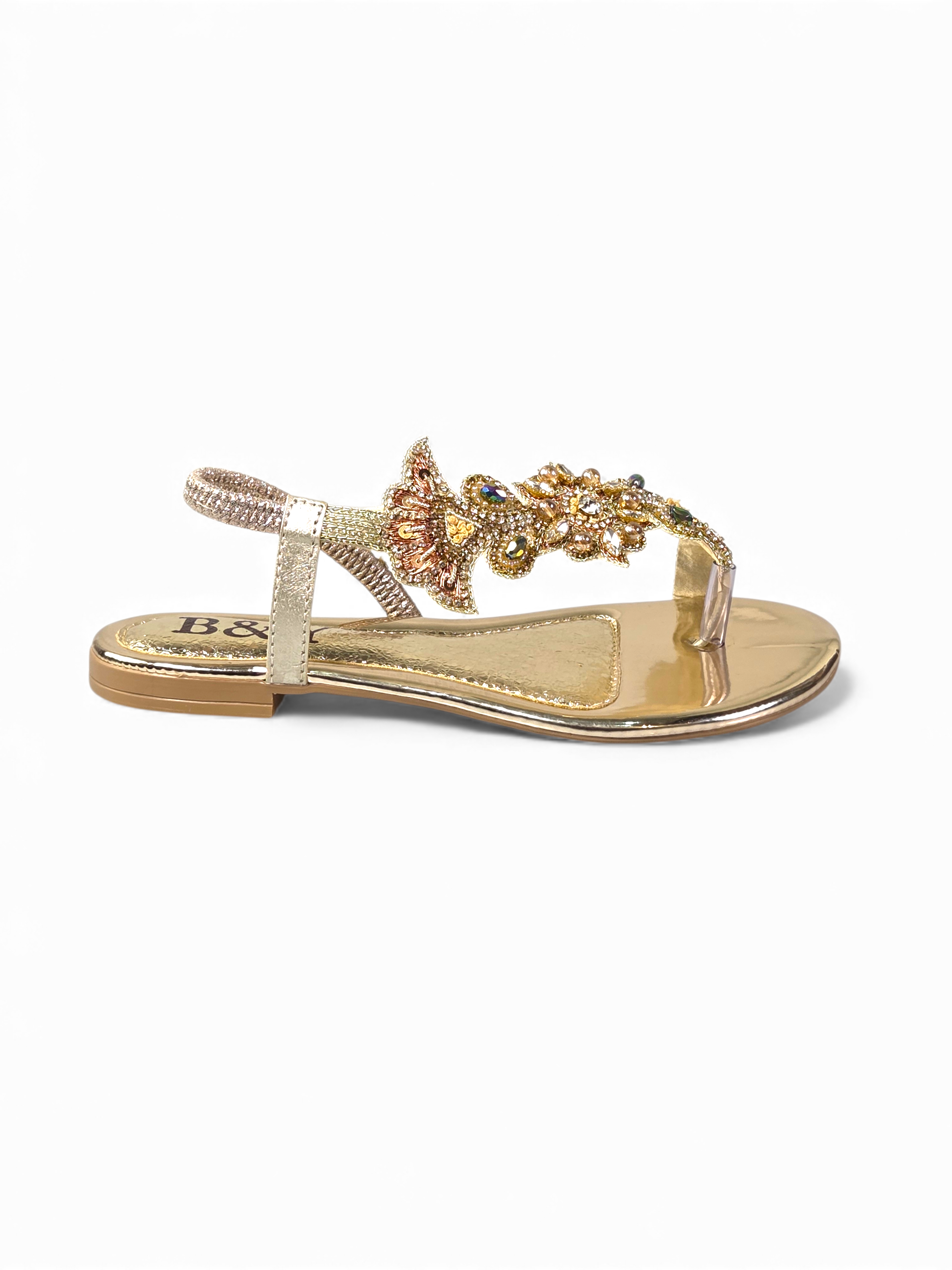 A pair of gold-colored, embellished sandals with a floral design.