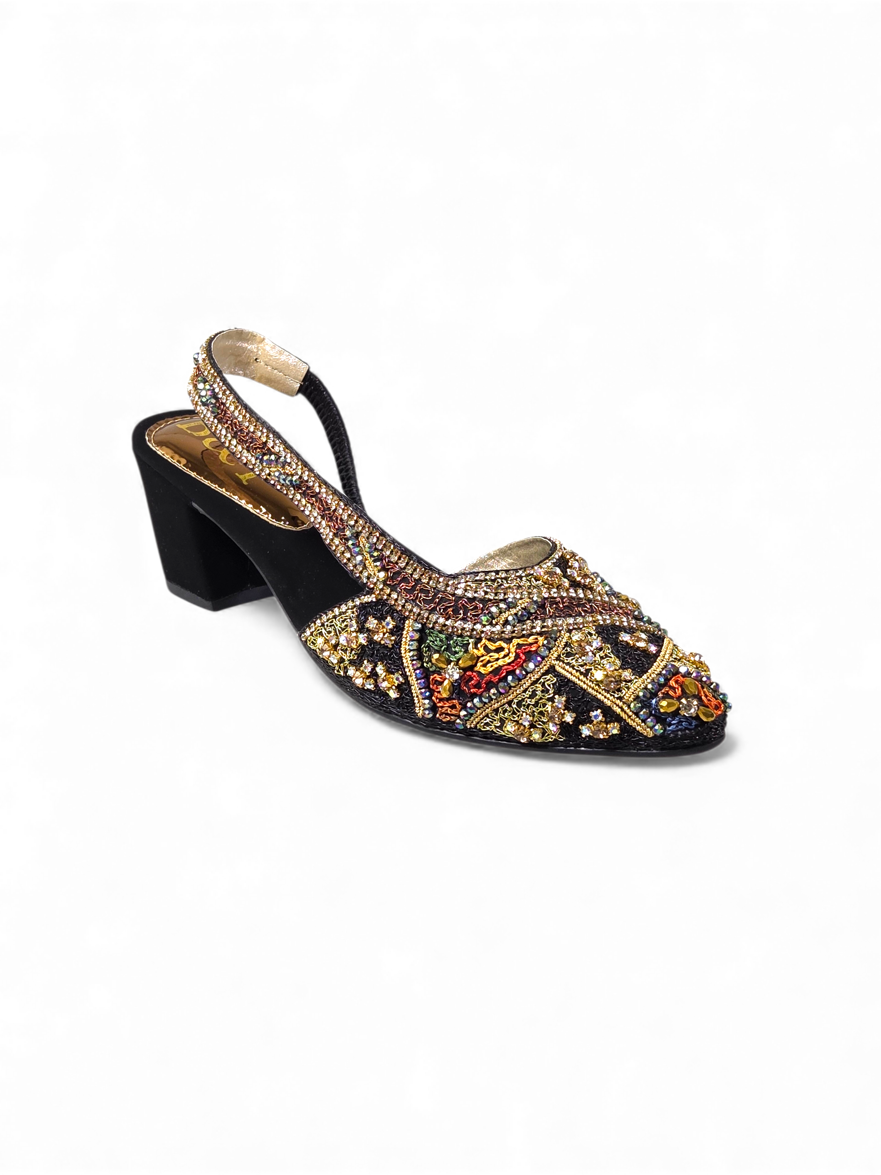 A black high-heeled shoe with a decorative beaded pattern and a strap across the top.