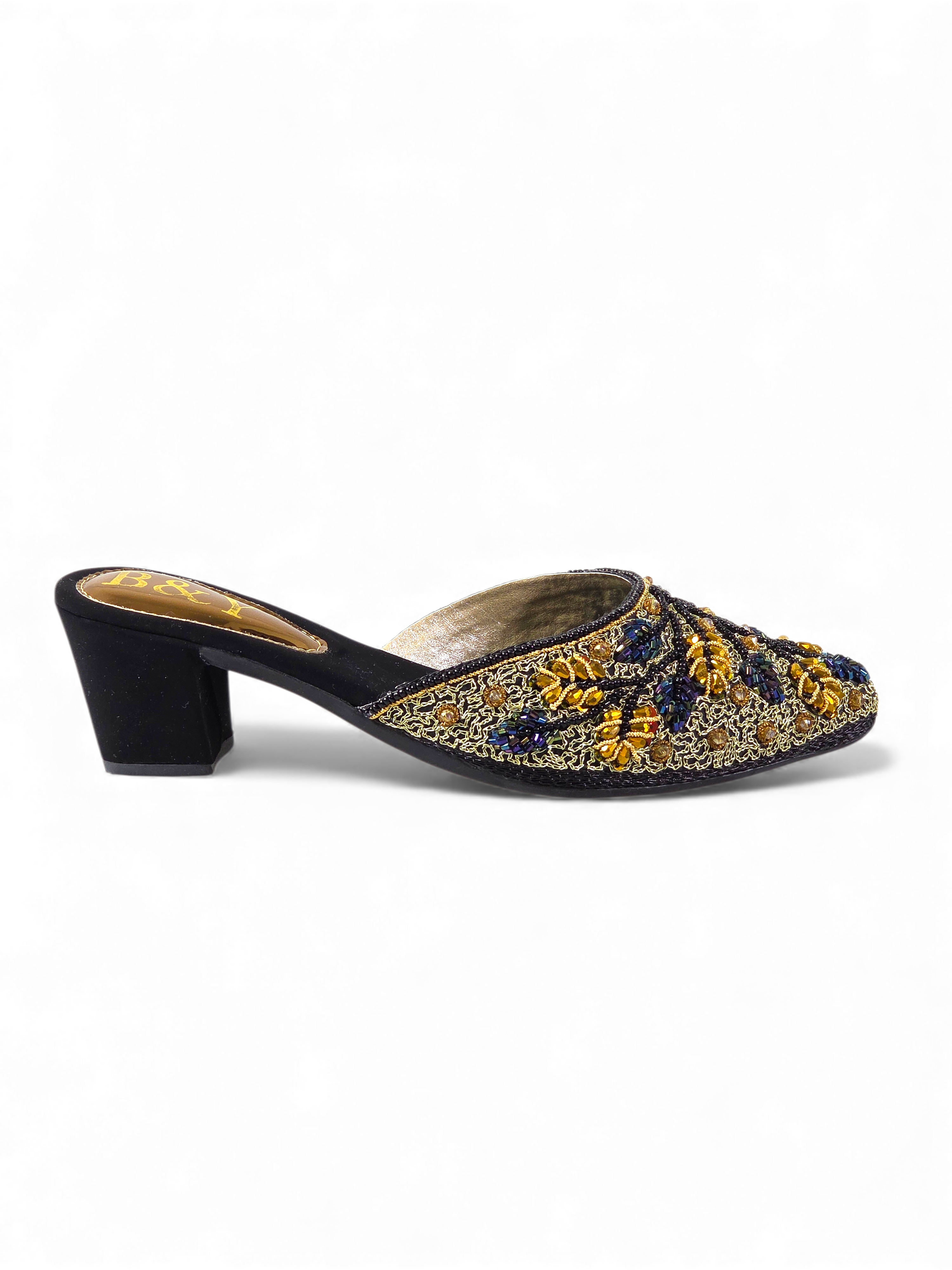 A pair of black and gold embellished mules or heeled sandals.