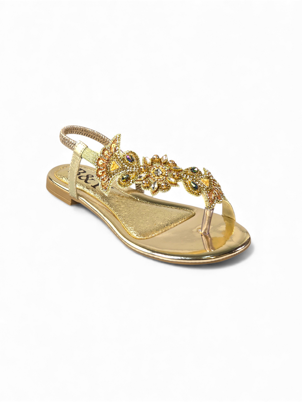 A gold-colored sandal with a decorative floral embellishment on the toe area.