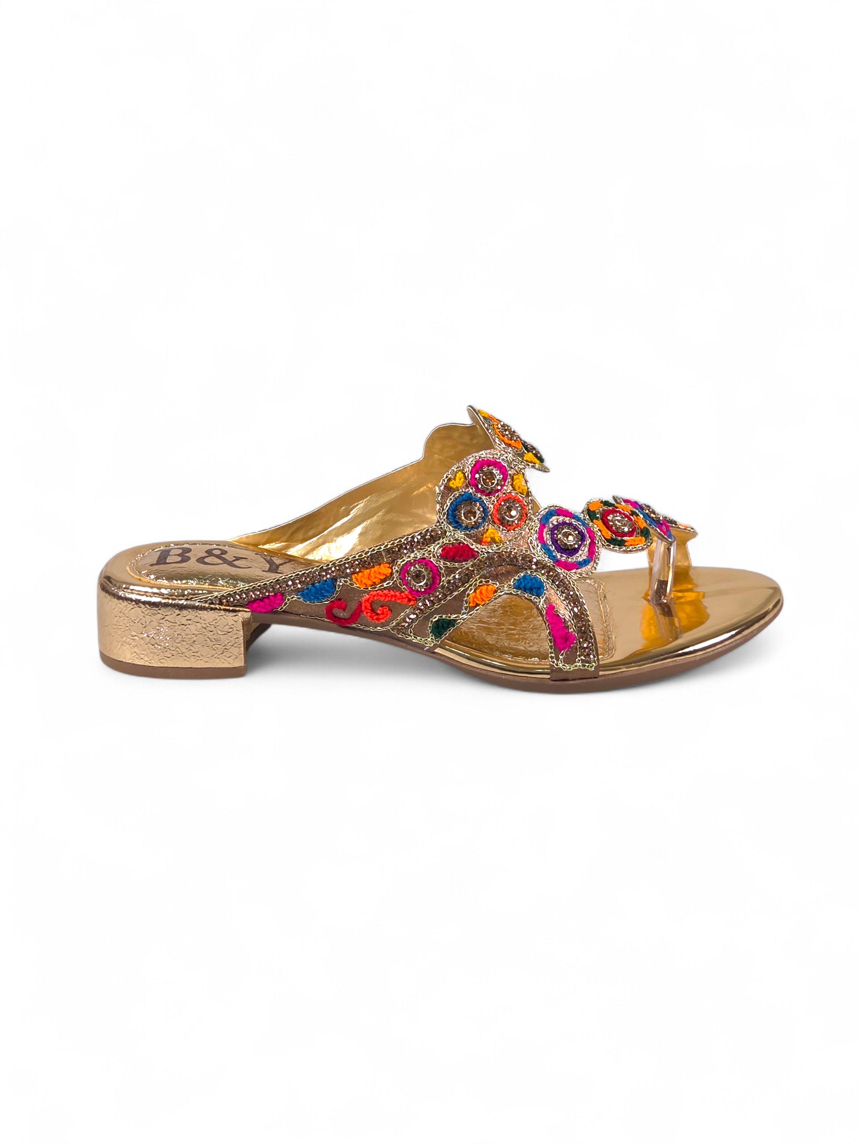 Sandália artesanal B&Y dourada com bordados multicoloridos, aplicação de cristais, salto baixo e acabamento sofisticado, em fundo branco.