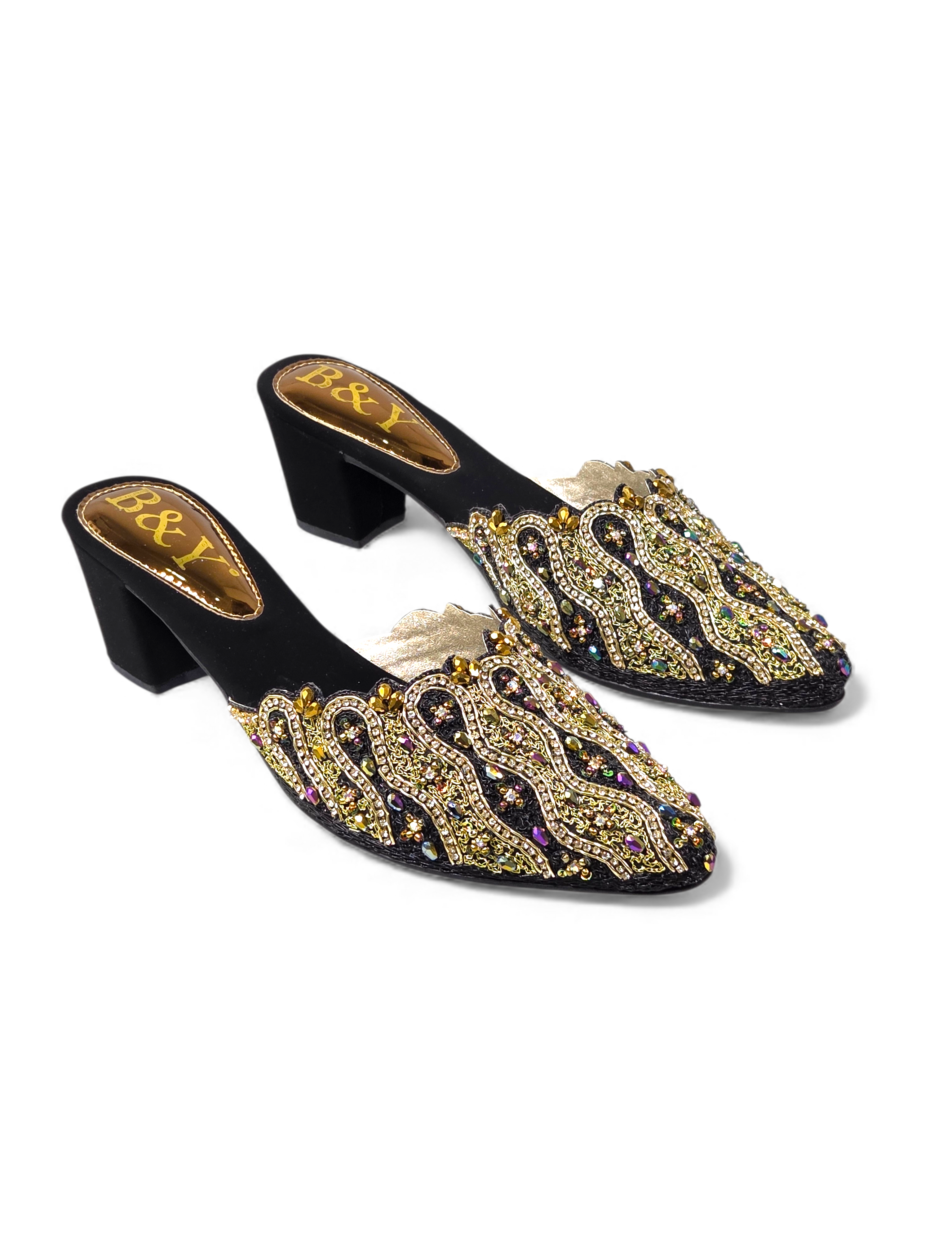 A pair of black and gold embellished mens shoes with intricate designs and rhinestones.