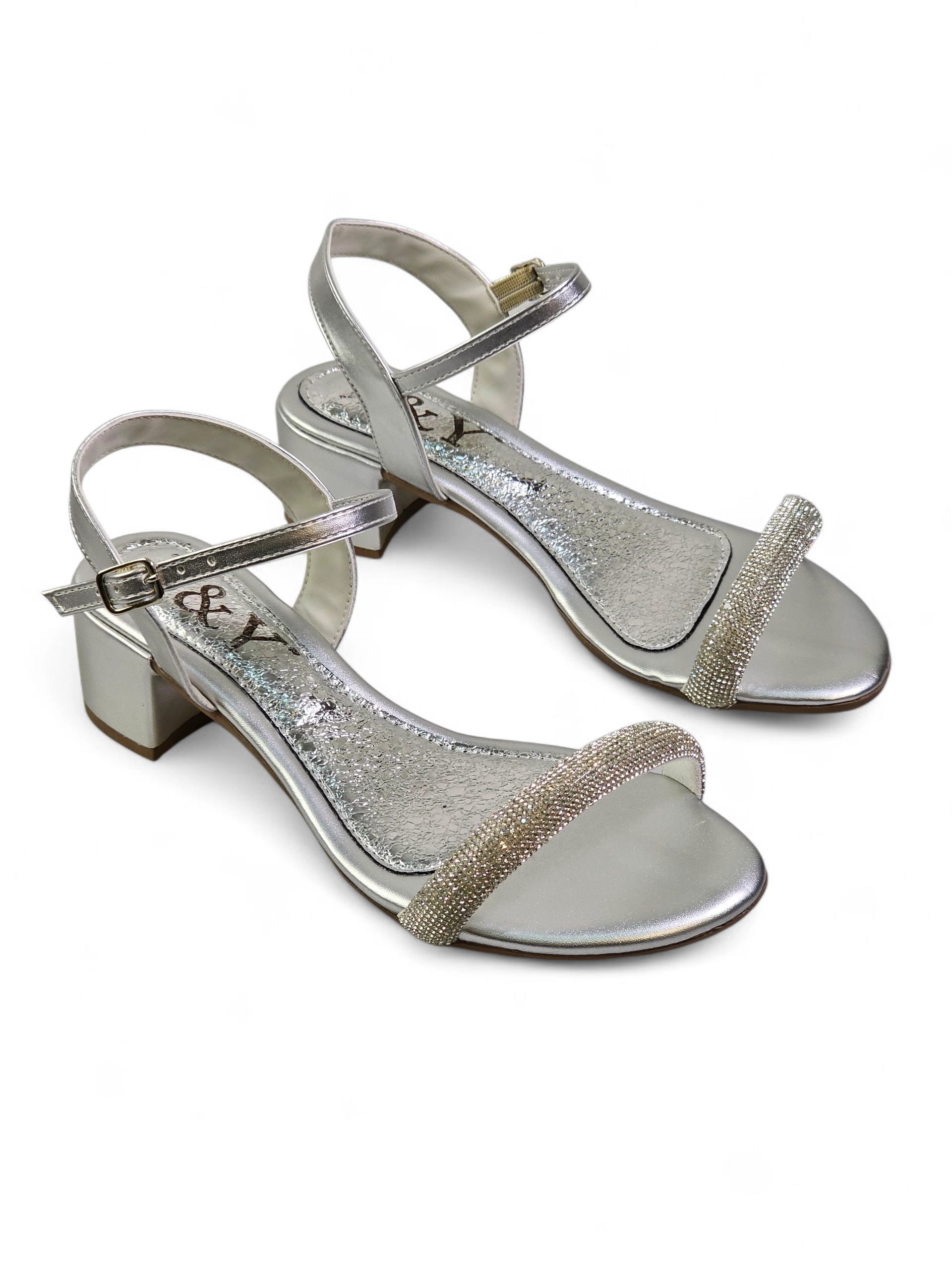 Sandália artesanal feminina prata feita à mão com pedrarias escuras e tiras finas no tornozelo.